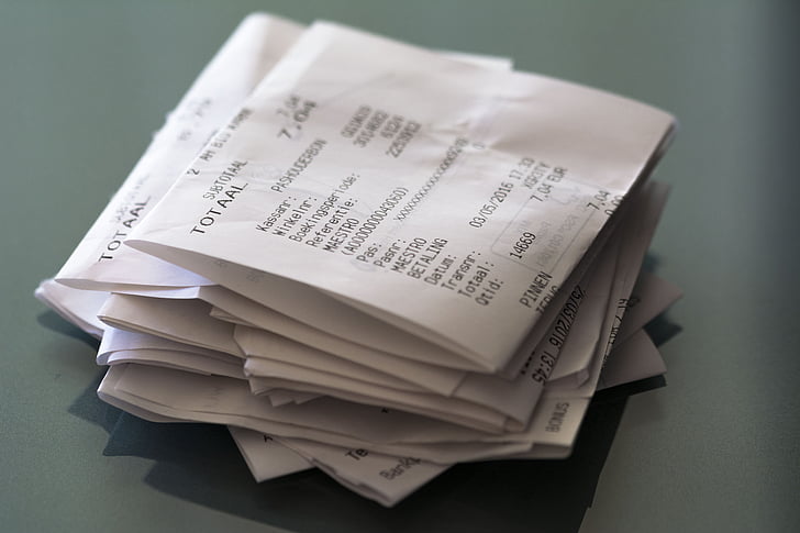 A pile of crumpled receipts on a desk